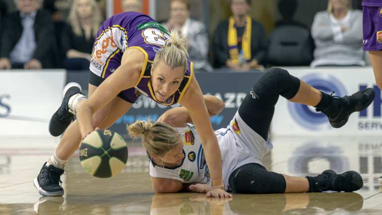 Nimble: Boomer Maddie Garrick leaps the Fire’s Brittany Smart and takes off on a fast break. 