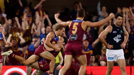 Kai Lohmann and Lachie Neale celebrate a goal.
