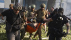 Rescuers carry a body of a resident killed in a Russian guided air bomb strike in Kharkiv, Ukraine, on Friday.