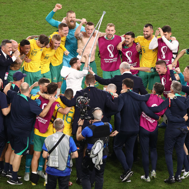 Graham Arnold and his team celebrate the historic win over Denmark.