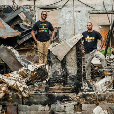 Ruhel Islam in the ruins of his Minneapolis restaurant, Gandhi Mahal, which was destroyed in the riots after George Floyd's death. Pictured here with his manager  and friend, Pastor Riz Prakasim. 