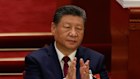 Chinese President Xi Jinping applauds during the opening session of the National People’s Congress or parliament in Beijing.