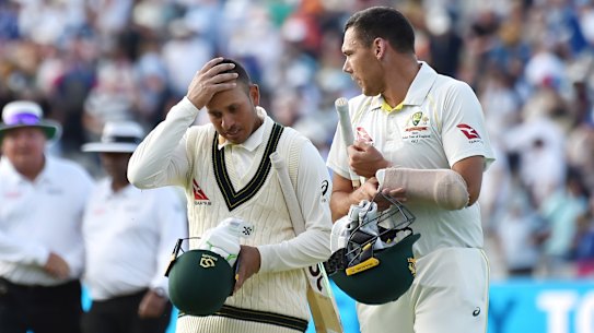 Usman Khawaja, left, and Scott Boland leave the pitch at the end of play during day four of the first Ashes Test.