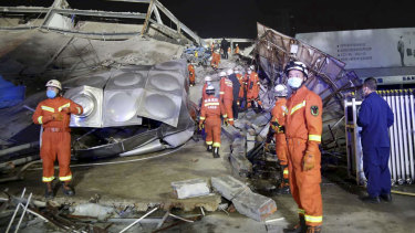 Rescuers work at the site of a collapsed five-story hotel building in Quanzhou city in southeast China's Fujian province. 