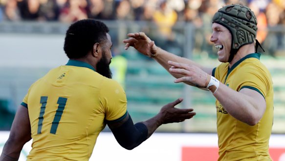 Resilient: Marika Koroibete and David Pocock celebrate after the winger scored a try against Italy. Pocock has been subject to a number of neck rolls this year.