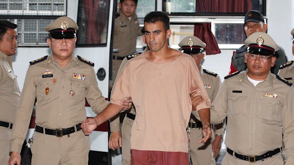 Hakeem Al-Araibi arrives at the Bangkok court on Monday with his legs shackled.