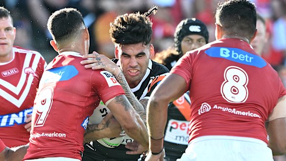 Terrell May charges into the Dolphins defence in round three. His stellar start at Wests Tigers has caught the eye of Blues coach Laurie Daley.