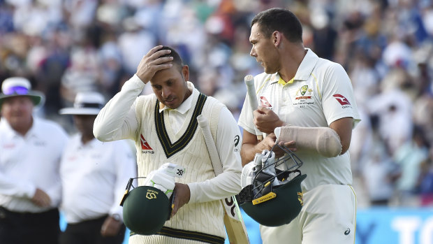 Usman Khawaja, left, and Scott Boland leave the pitch at the end of play during day four of the first Ashes Test.