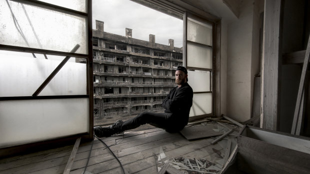 A Shane Thoms self-portrait taken among derelict housing on Japan’s Hashima Island, once mined for coal but now abandoned.