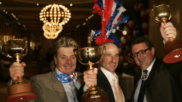 Tony Santic [owner], Glenn Boss [jockey] and Lee Freedman [trainer] celebrate  the third Melbourne cup win.