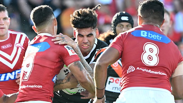 Terrell May charges into the Dolphins defence in round three. His stellar start at Wests Tigers has caught the eye of Blues coach Laurie Daley.