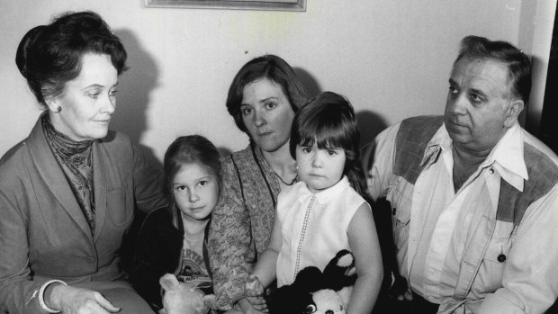 Lorraine Warren (left) with the family who were frightened out of their Gladesville home.