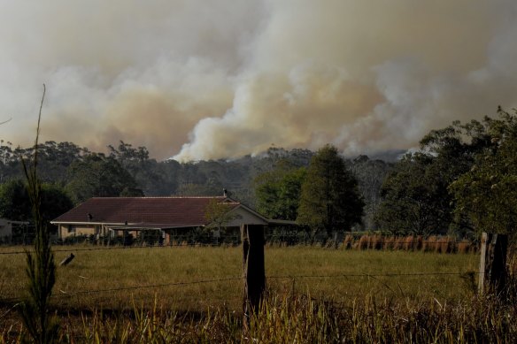 Smoke rises from the bushfires near the intersection of The Lakes Way and Blackhead Road, north of Forster-Tuncurry.
