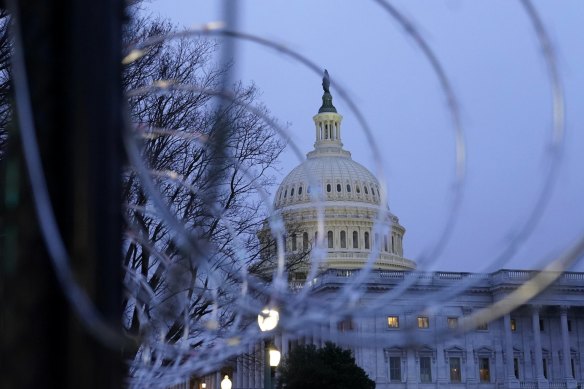 The US Capitol dome is seen past security fencing and barbed wire erected after the deadly January 6 riots.