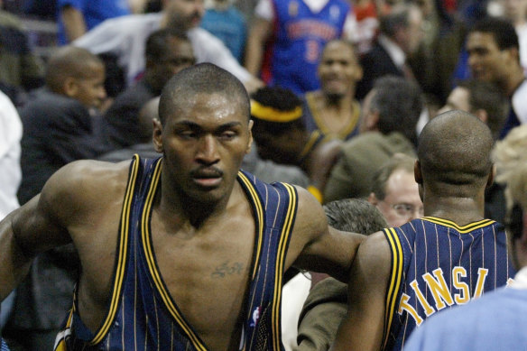 Indiana forward Ron Artest returns to the court after charging into the crowd.