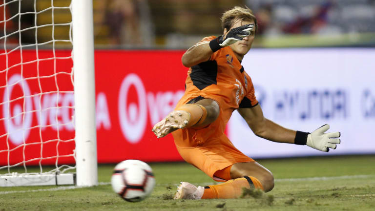 Beaten: Jets goalkeeper Lewis Italiano, who replaced Glen Moss at half-time, fails to save a Craig Goodwin penalty.