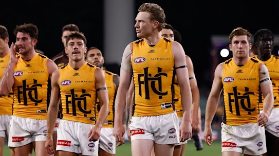 James Sicily leads a dejected-looking Hawthorn from the field at Adelaide Oval.