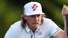 Cameron Smith of Australia lines up a putt on the 18th green during the first round of the 2024 Masters.