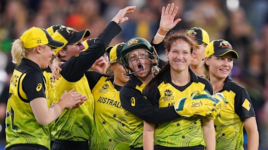 Schutt to thrill: The Australian women's team celebrate after Megan Schutt (second from right) dismissed India's Shikha Pandey in the T20 World Cup final at the MCG.