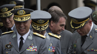 Brazil's President Jair Bolsonaro pictured with Army officers in December. Bolsonaro is a former Army captain.