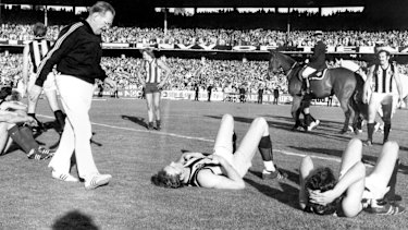 Exhausted players after the final siren of the drawn 1977 Grand Final.