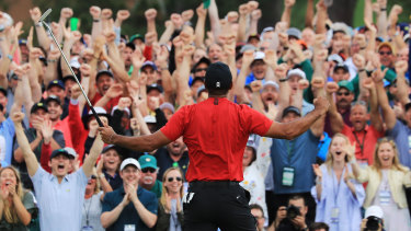 Woods celebrates with the crowd after sinking his winning putt at Augusta in April.
