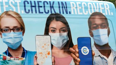 People wait in line at a Miami-Dade County COVID-19 testing site.