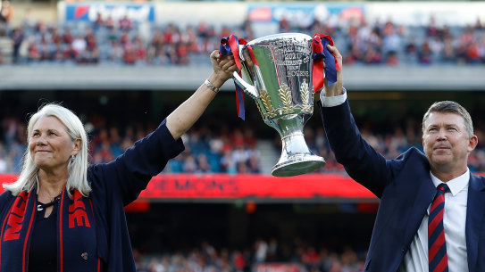 High point: Melbourne president Kate Roffey and CEO Gary Pert show off the premiership cup at the MCG in March.