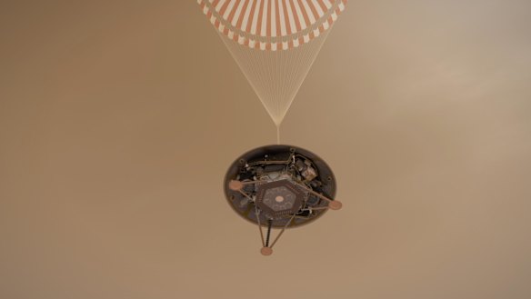 InSight hangs via its parachute in this illustration.