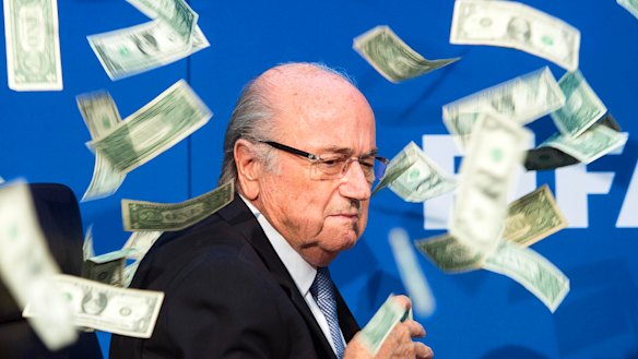Former FIFA president Joseph Blatter being showered with banknotes by Brodkin during a 2015 press conference.