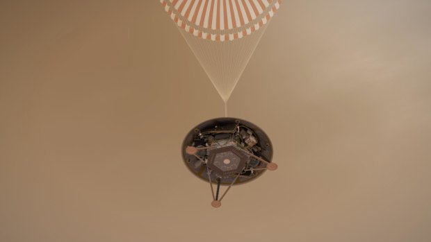 InSight hangs via its parachute in this illustration.
