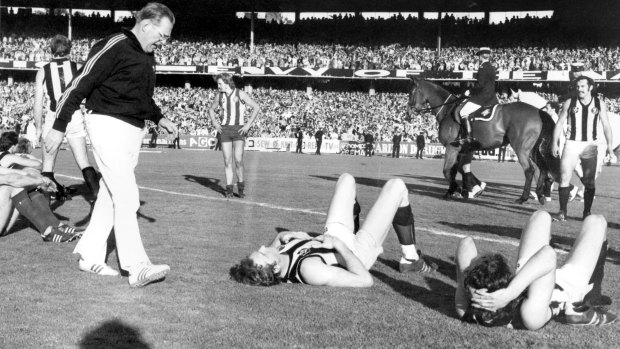 Exhausted players after the final siren of the drawn Grand Final.