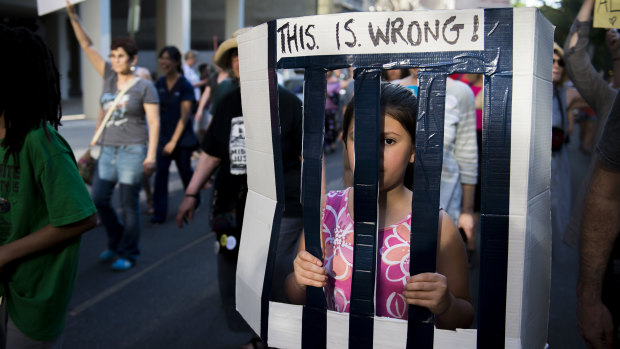 A child protests against the separation of families in Philadelphia.