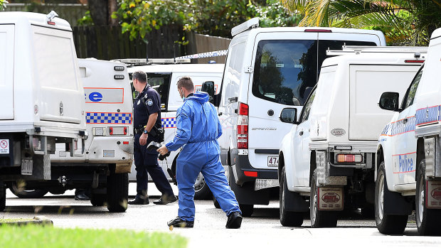 Scientific and forensic police officers scoured the Petrie street on Friday.
