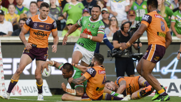 Back foot: Joey Leilua charges through the Broncos defence on Sunday.