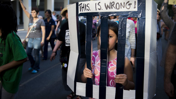 A child protests against the separation of families in Philadelphia.