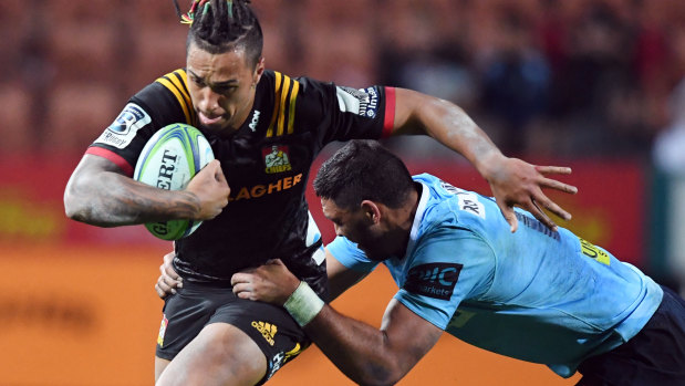 Breakthrough: Sean Wainui of the Chiefs, left, held back by Kurtley Beale of the Waratahs.