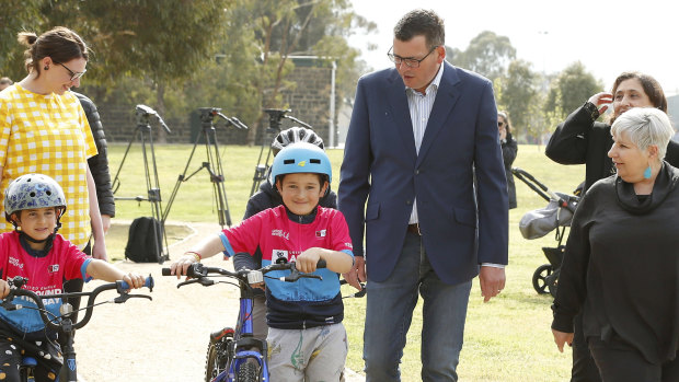 Premier Daniel Andrews walks through Hansen Reserve in West Footscray with children on bikes after announcing the winners of Pick My Project.