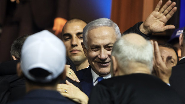 Benjamin Netanyahu, Israel's prime minister, centre, greets attendees at the Likud party headquarters in Tel Aviv, Israel. 