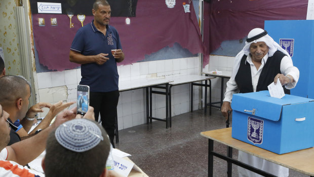 Israeli bedouin arabs cast their votes in a polling station in the city of Rahat, Israel, on Tuesday.
