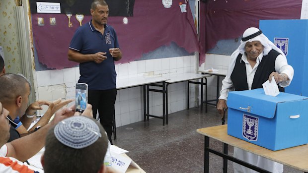 Israeli bedouin arabs cast their votes in a polling station in the city of Rahat, Israel, on Tuesday.