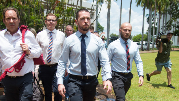 Constable Zachary Rolfe (centre) leaves the Northern Territory Supreme Court after an appearance in March 2022.
