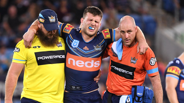 Early casualty: Jai Arrow leaves the field on Friday night after injuring his ankle during the Titans' loss to the Warriors.
