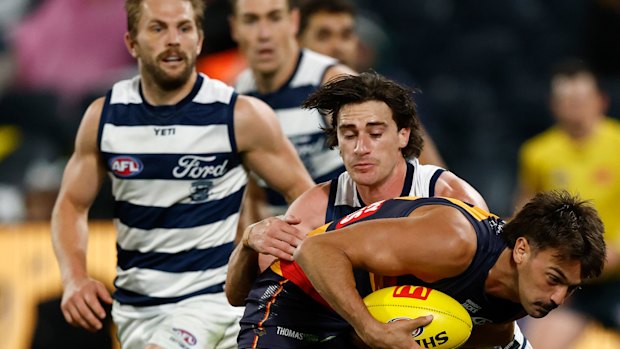Gryan Miers wraps Luke Nankervis up in a tackle.