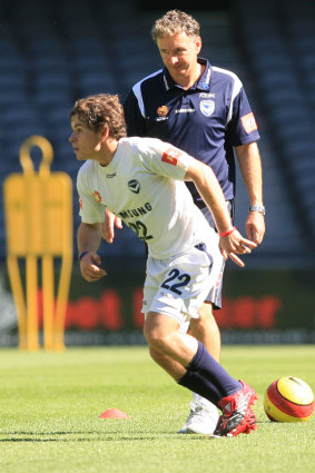 Then-Victory coach Ernie Merrick keeps a close eye on a young Leigh Broxham at training in 2007.