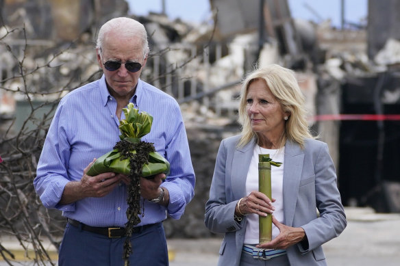 US President Joe Biden and first lady Jill Biden participate in a blessing ceremony with elders as they visit areas devastated by the Hawaii fires.
