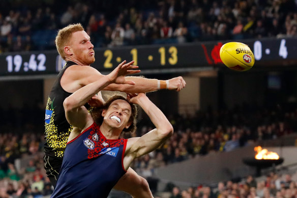 Nick Vlaustuin punches the ball clear of Ben Brown.