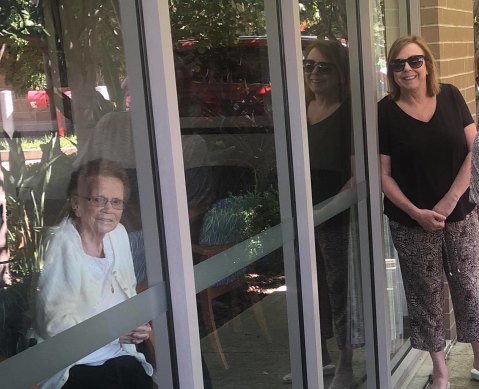 Mary Watson, right, visited her mother, Alice Bacon, at Newmarch House through the window for her birthday on April 5.