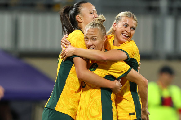 Tameka Yallop, Amy Sayer and Charlotte Grant of the Matildas celebrate a goal.