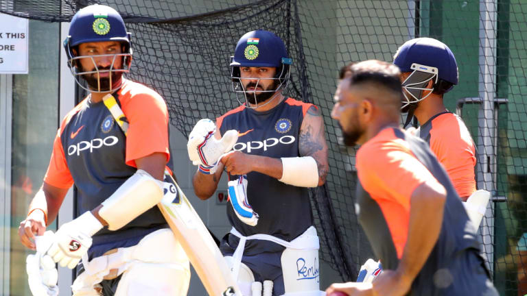 Circling the wagons? Virat Kohli (centre) prepares to bat in the MCG nets. 